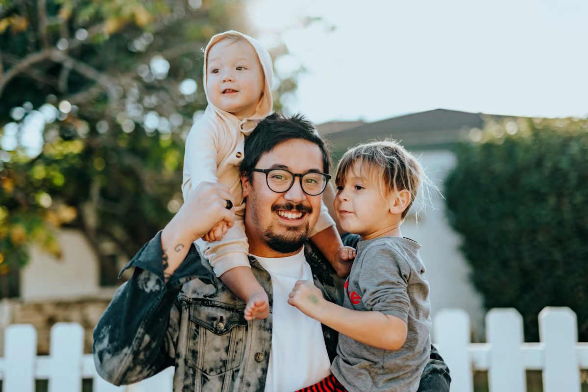 Happy family in front of their new home in the community