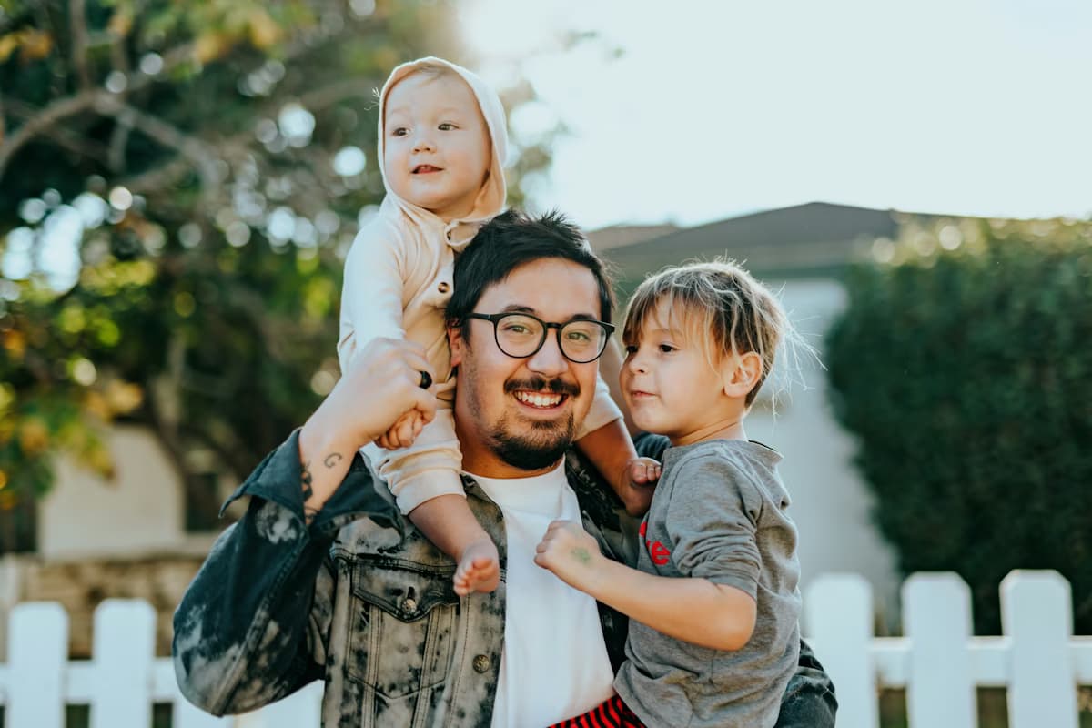 Happy family in front of their new home in the community